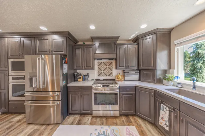 Close up view of the kitchen showing the farm sink and staggered cabinets