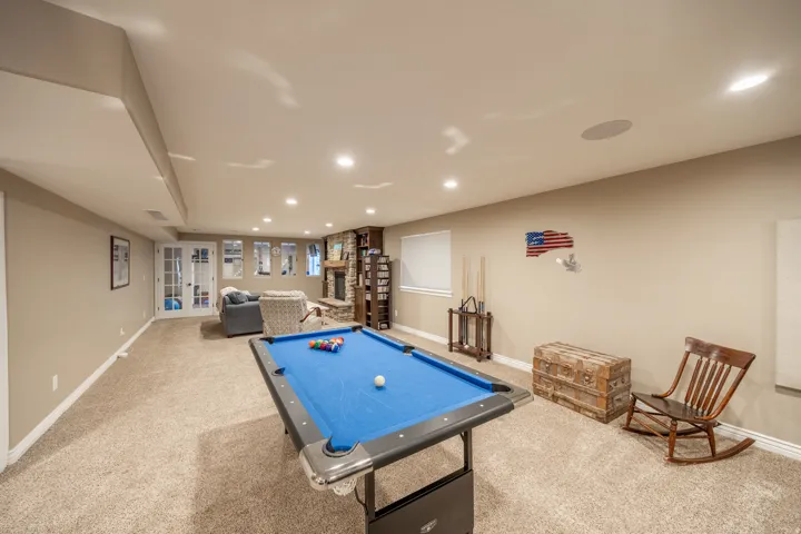 The downstairs family room is so large you can have a game table, a conversation area around the fireplace and the theatre area.