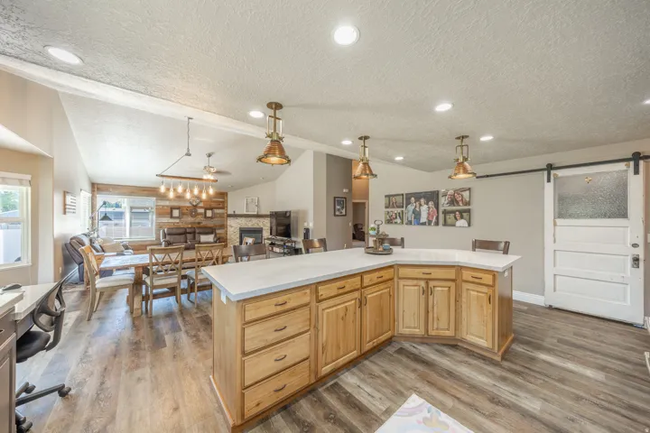 Another view of the island showing a barn door with frosted glass which conceals the pantry