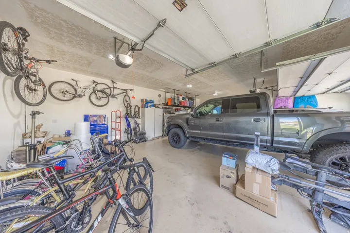 Spacious garage has extra width, height, and length and also has newer garage door openers.