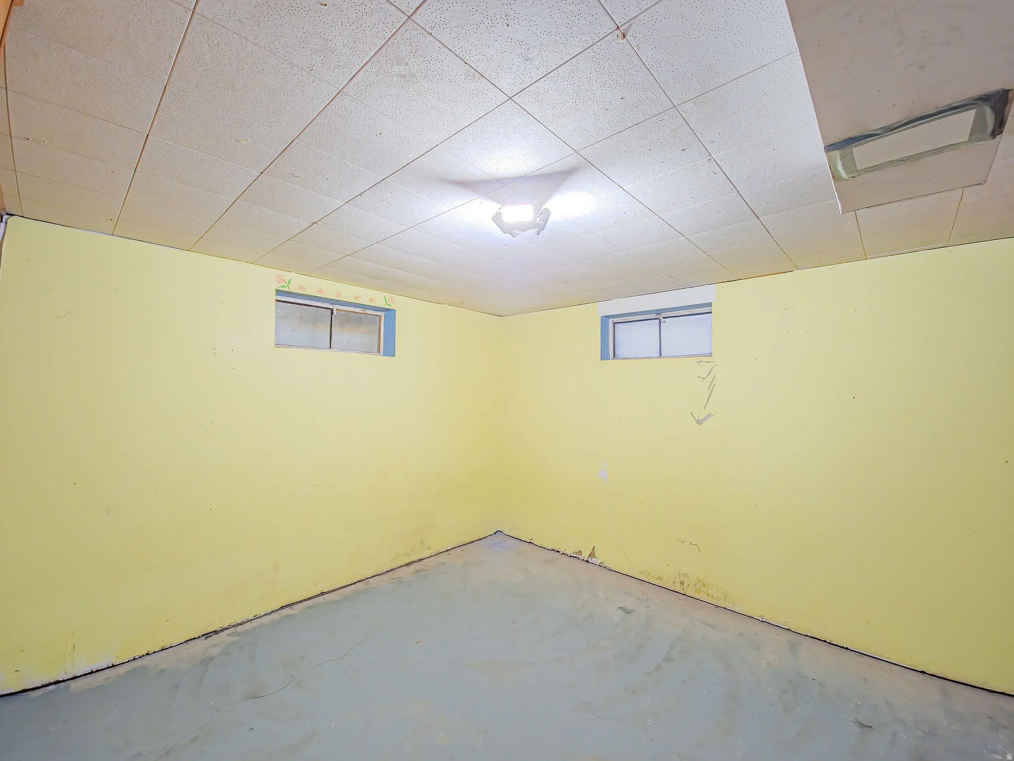 Recessed ceiling tiles, built-in ceiling light fixture, two fixed-pane windows