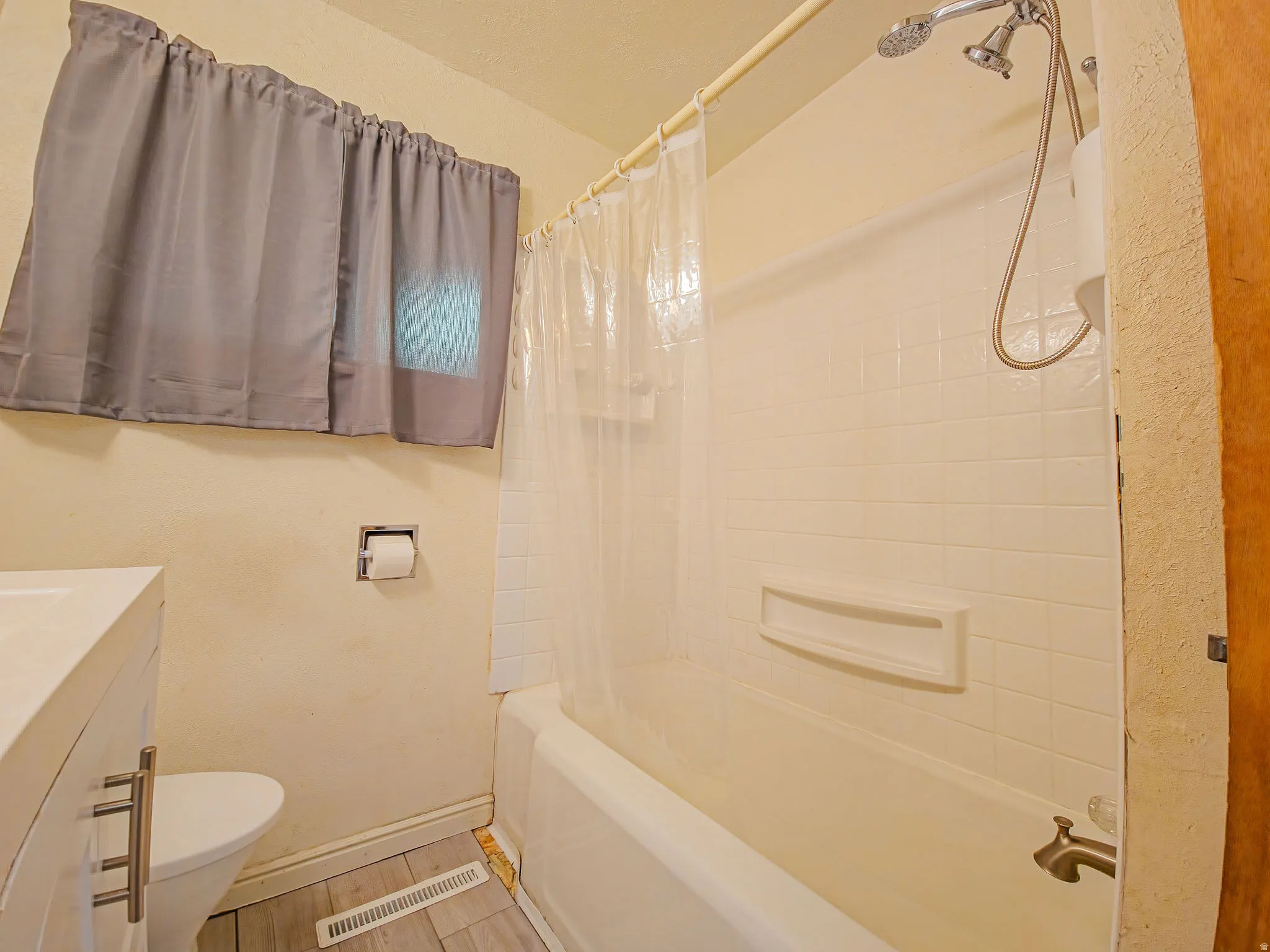 White tiled shower surround with an integrated soap dish and a tub