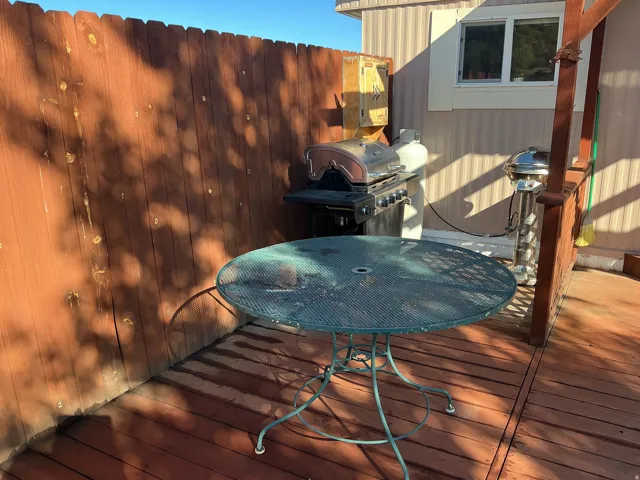 Wood deck with a privacy fence and exterior siding