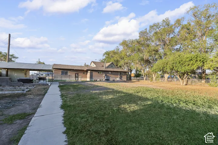 Expansive grass areas, mature trees, and a concrete pathway
