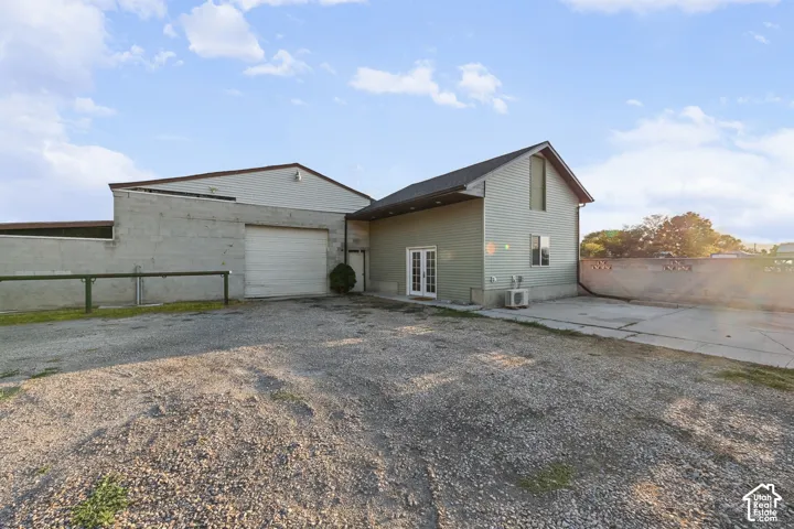Two-story structure with siding exterior and an attached concrete block building