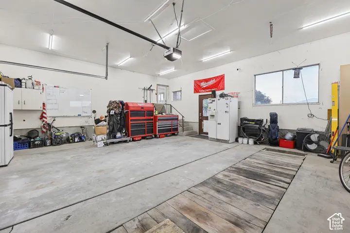 Concrete flooring, overhead lighting, window, built-in cabinetry, interior door