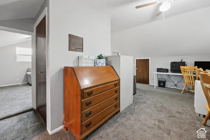 Sloped ceilings, wall-to-wall carpeting, and a ceiling fan
