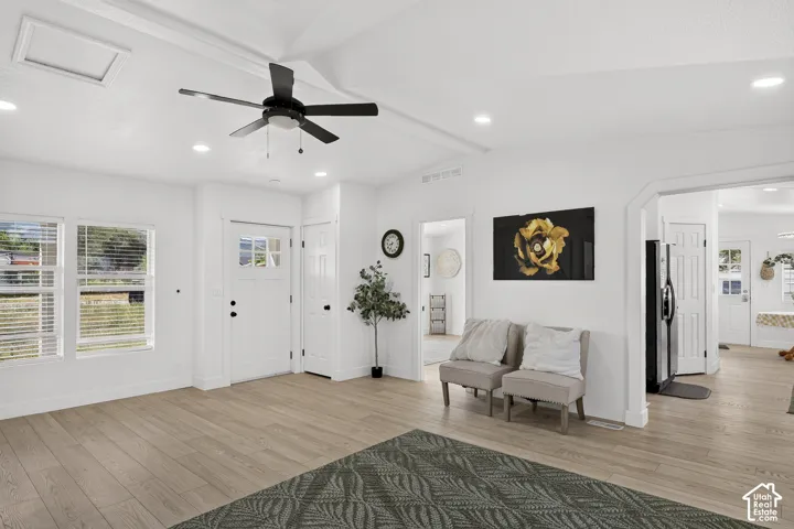 Vaulted ceiling with recessed lighting and ceiling fan