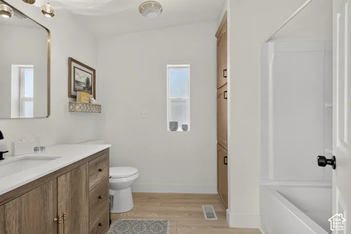 Wood-finish vanity with an integrated sink and white countertop