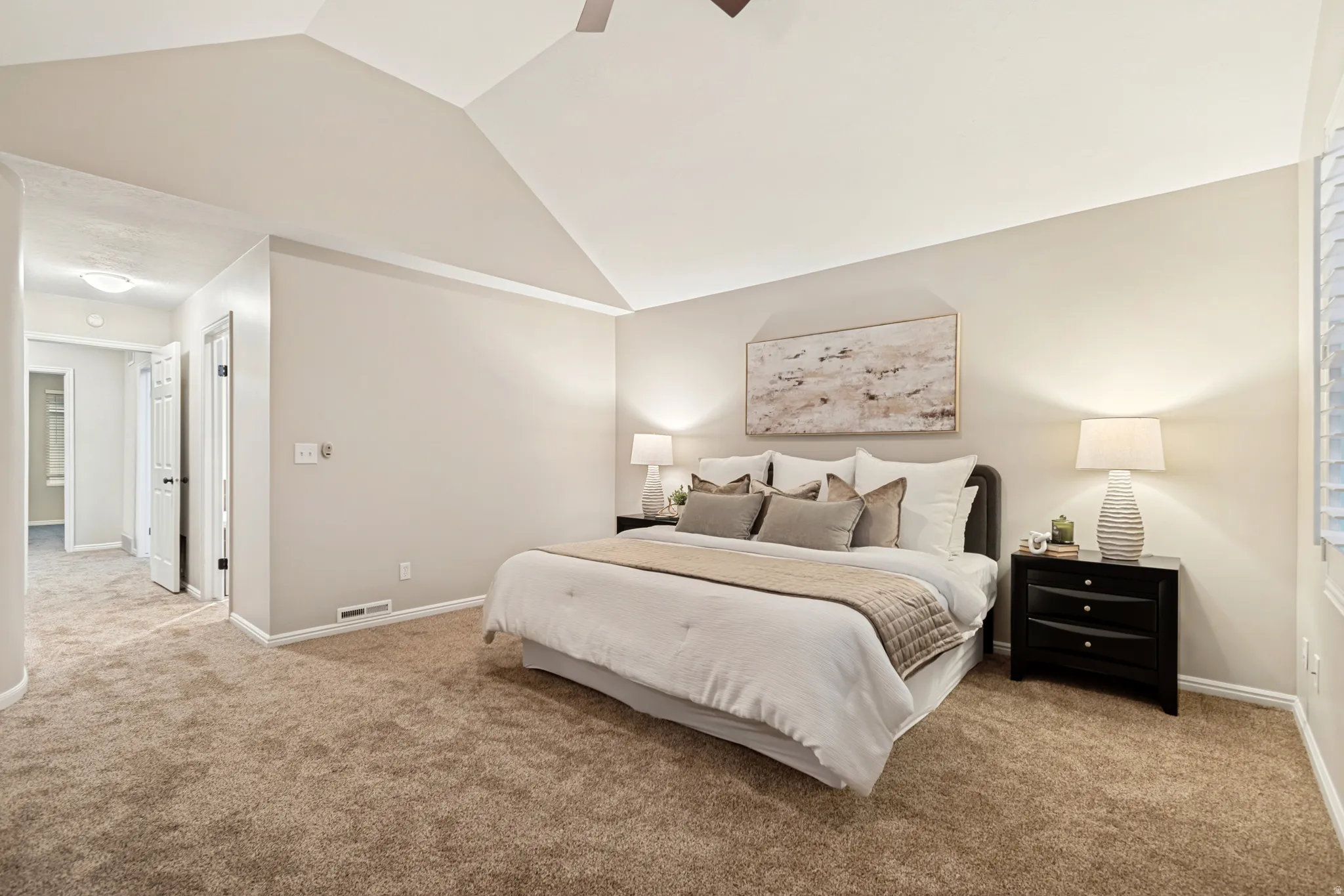 Vaulted ceiling, plush carpet flooring, recessed lighting, and a white interior door