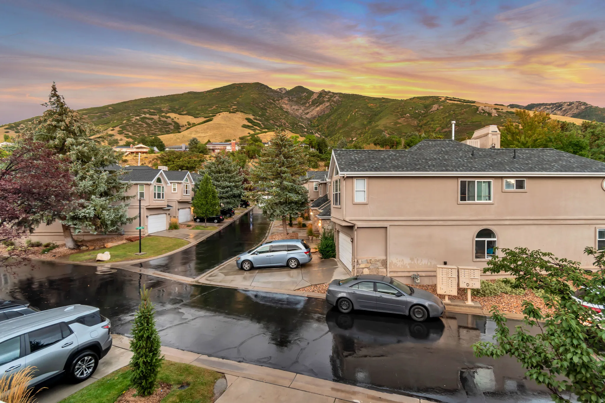 Townhome with attached garage, stucco exterior, and multi-paned windows
