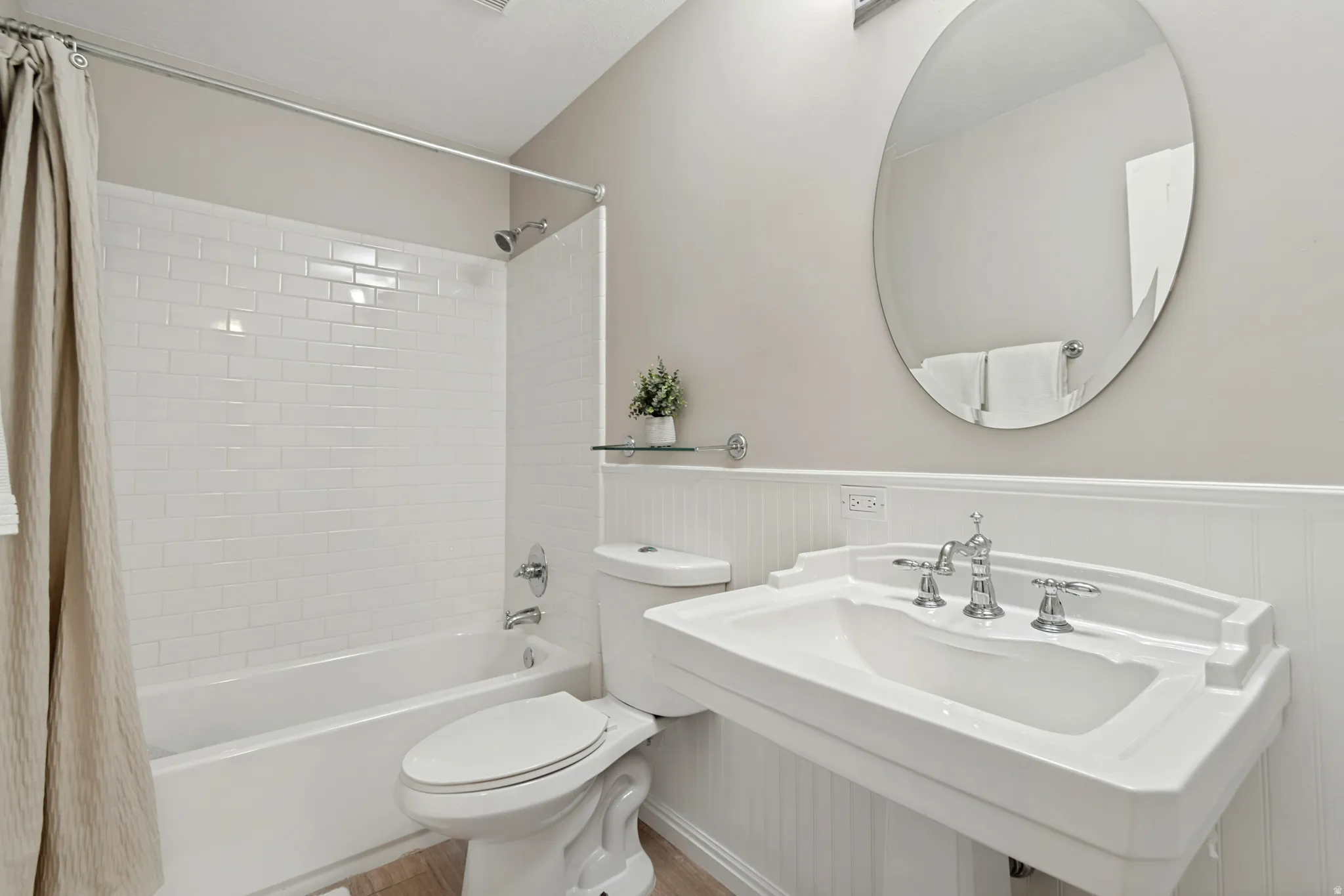 Bathtub featuring white subway tile surround