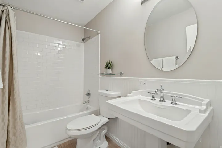 Bathtub featuring white subway tile surround