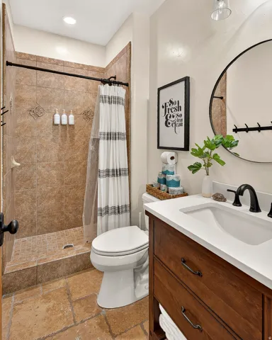 Tiled shower with a dark bronze shower rod