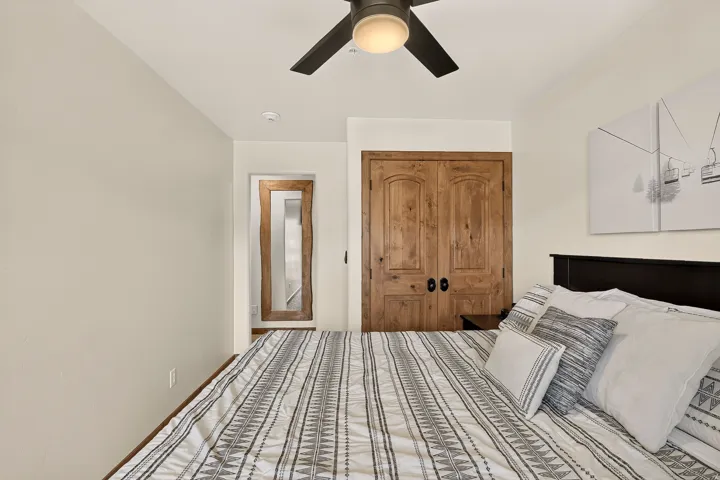Recessed lighting, wood-finish bi-fold closet doors, ceiling fan with integrated lighting, and wood-finish door frames