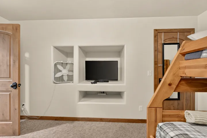 Built-in wall niches, wood-finish doors, and plush carpet flooring