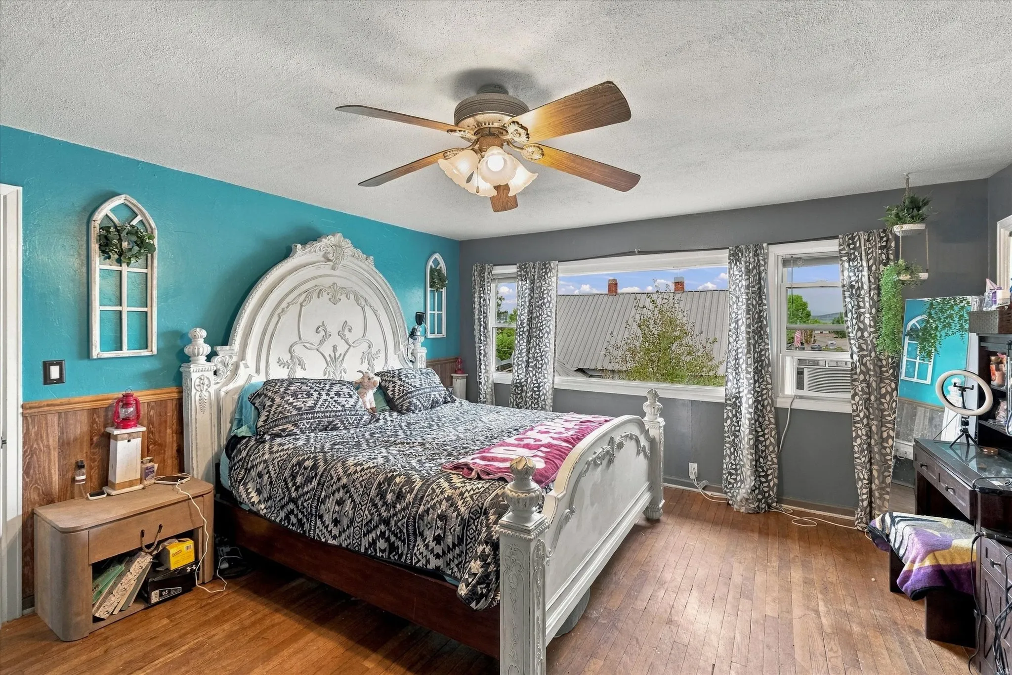 Wood-finish flooring throughout, bright walls, and multiple windows
