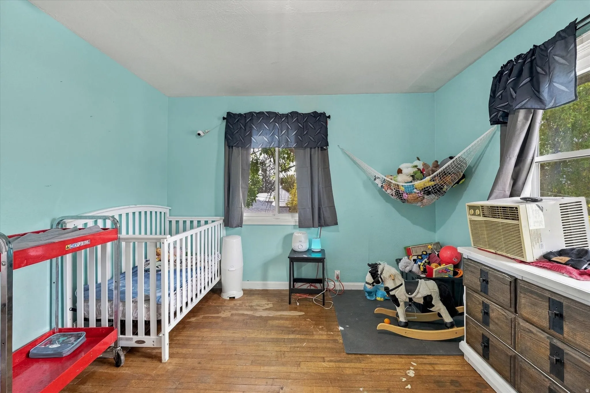 Hardwood flooring, painted walls, and window treatments