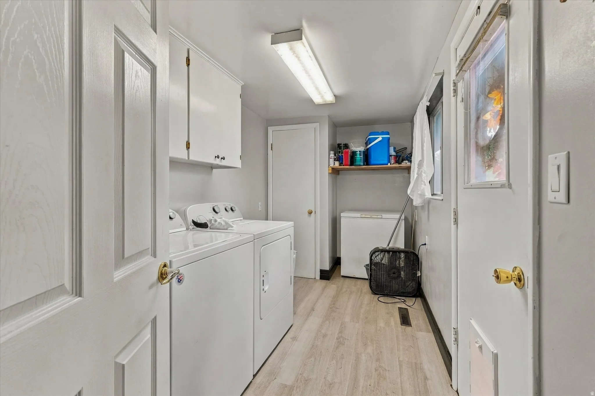 Wood-finish flooring with white paneled doors
