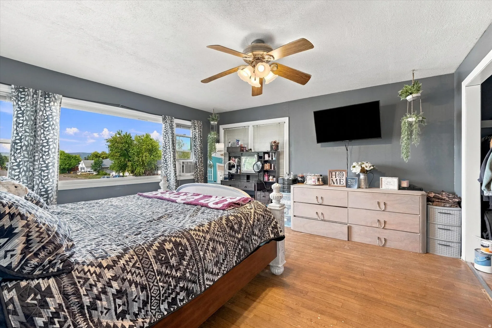 Wood-finish flooring with a ceiling fan light fixture