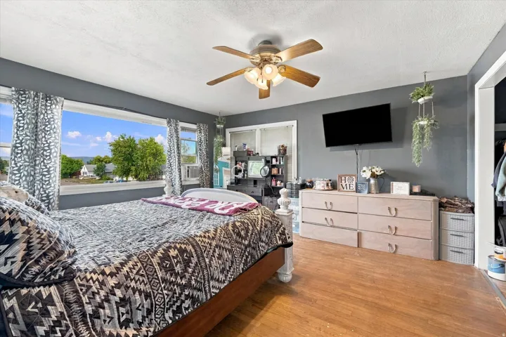 Wood-finish flooring with a ceiling fan light fixture