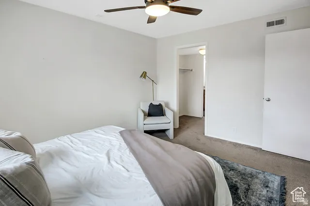 Neutral wall paint, ceiling fan with integrated lighting, and carpeted flooring