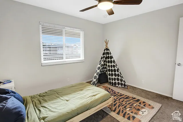 Window with horizontal blinds and a ceiling fan with integrated lighting