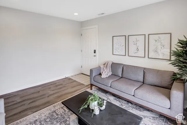 Recessed ceiling lighting, wood-finish flooring, and light wall color