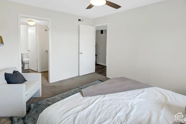 Neutral wall paint, ceiling-mounted light fixture, and wood-finish ceiling fan