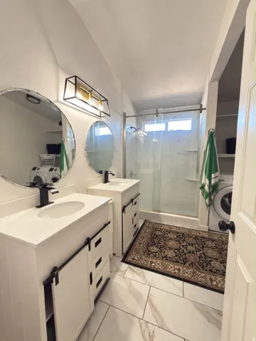 Dual vanities with white countertops and integrated sinks