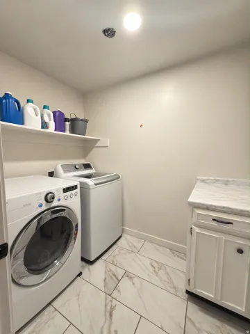 White tile flooring, white shaker-style cabinetry, and a white countertop