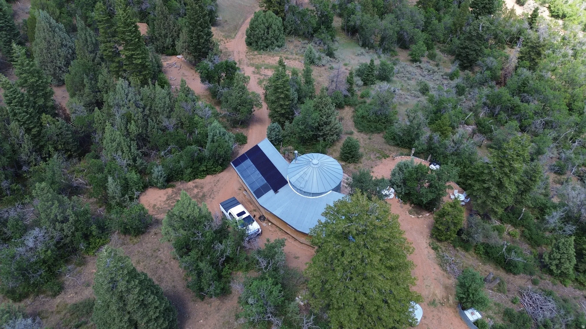 Dome-style residence with a metal roof and solar panel array