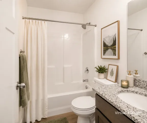 Bathroom featuring a tub/shower combination, wood-finish flooring, a toilet, a vanity with granite-style countertop, and an integrated sink