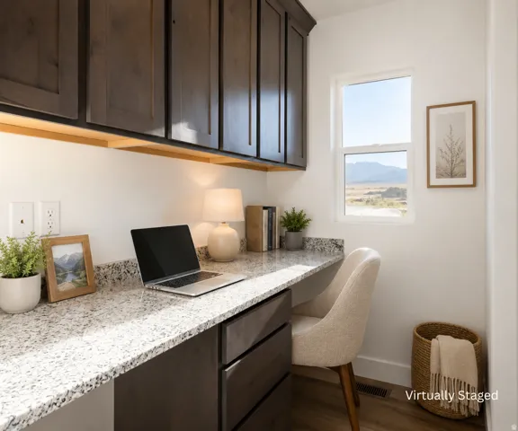 Built-in desk featuring a light-toned speckled countertop and dark wood-finish cabinetry