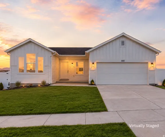 Crisp white exterior siding with board and batten accents, a two-car garage, and multiple window configurations