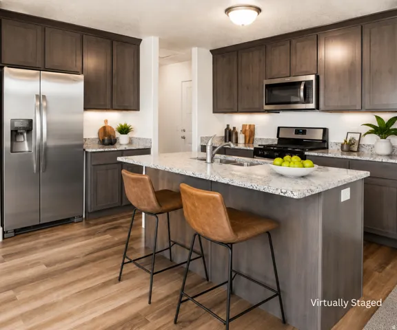 Kitchen with wood-finish flooring, dark wood-finish cabinetry, stainless steel appliances, speckled stone countertops, and a center island with an integrated sink