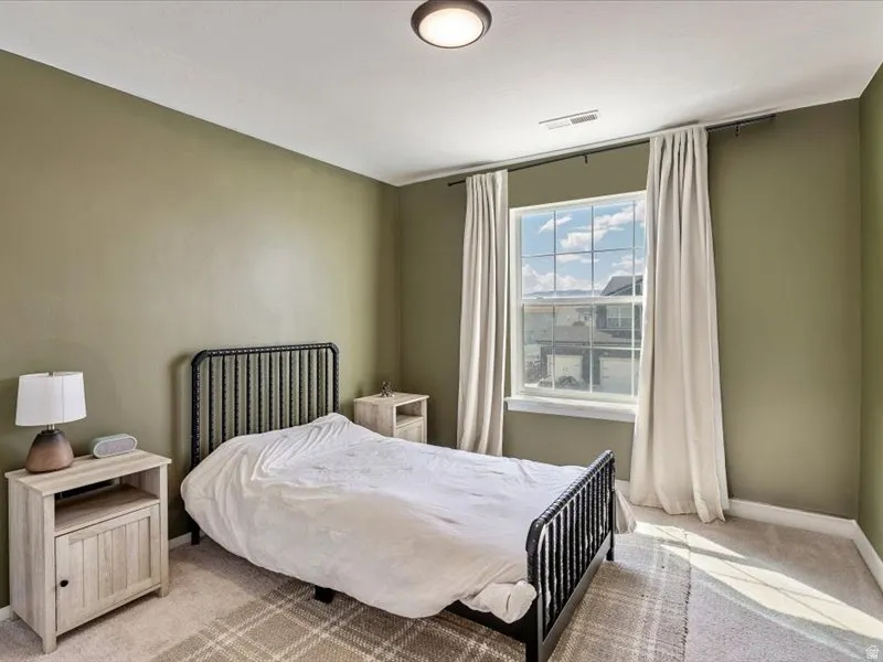 Neutral-toned walls complement the carpeted flooring