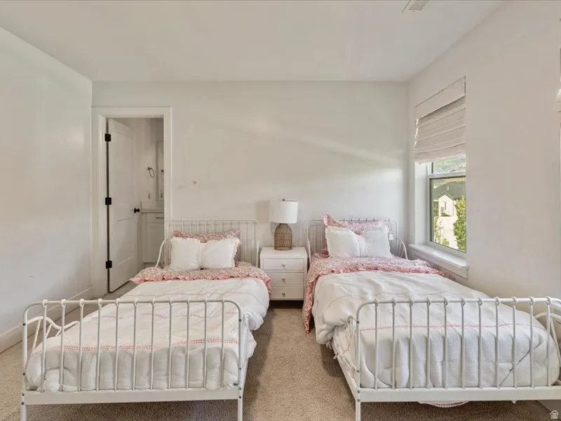 Bright room with a large window, neutral wall paint, and carpet flooring