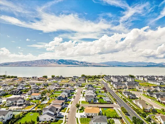 Expansive residential area with a prominent lake and mountain range backdrop