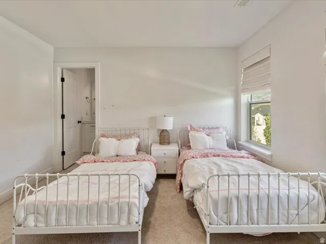 Bright room with a large window, neutral wall paint, and carpet flooring