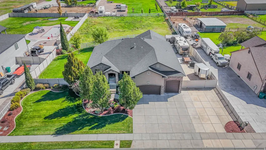 Stone and stucco exterior with a dark shingle roof