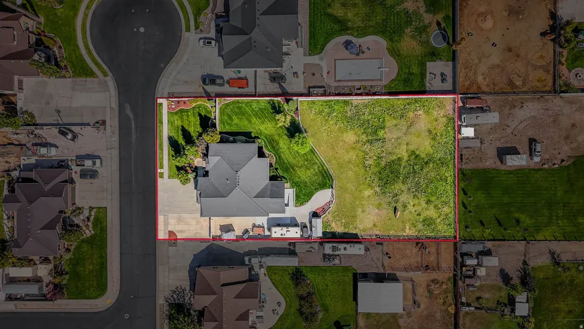 Expansive lot featuring a residential structure, paved driveway, and substantial undeveloped land