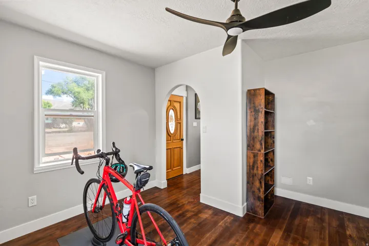 Recessed lighting, wood-finish flooring, and an arched doorway