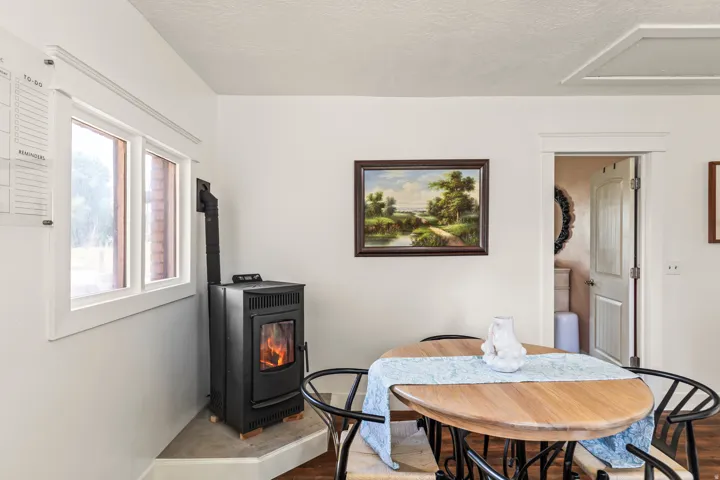 Freestanding hearth on a raised platform, wood-finish flooring, and white trim