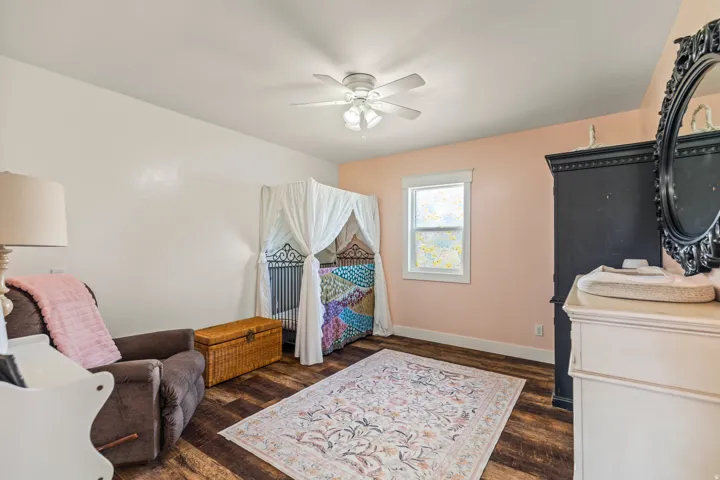 Wood-finish flooring with a ceiling fan overhead