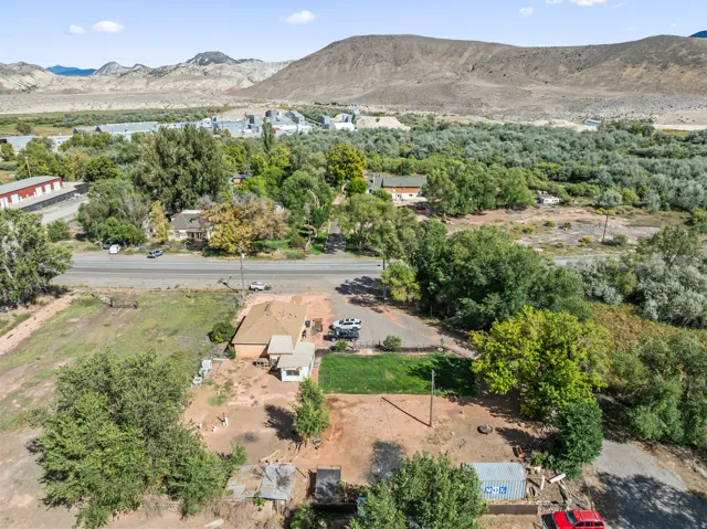 Expansive lot with partial green lawn and mature trees