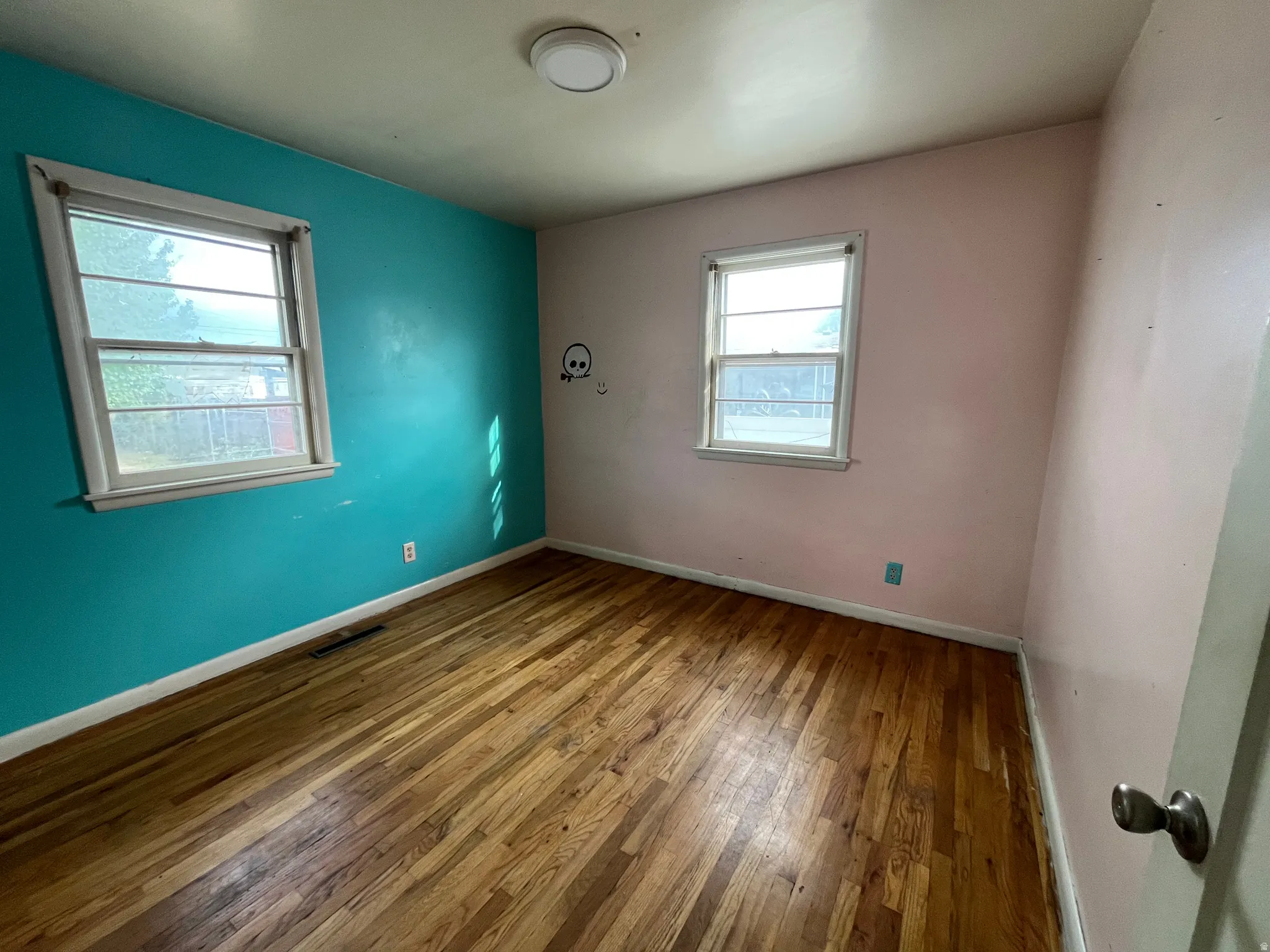 Charming bedroom featuring classic hardwood floors
