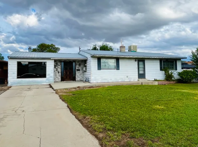 Exterior featuring a durable metal roof and clapboard Masonite siding.