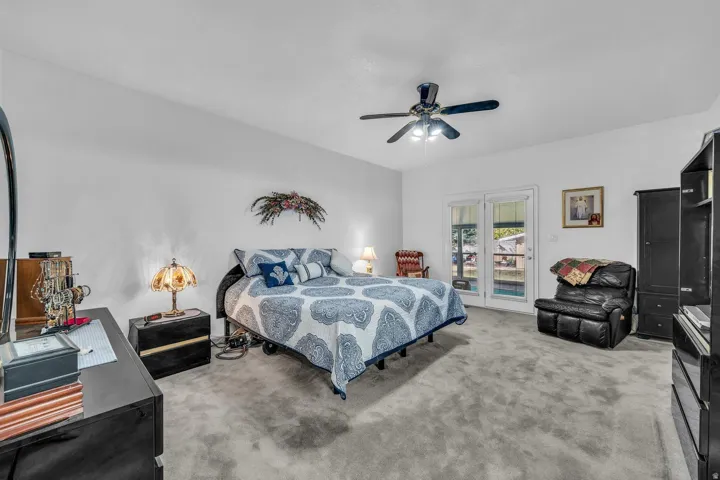 Spacious room with light gray carpeting and white walls