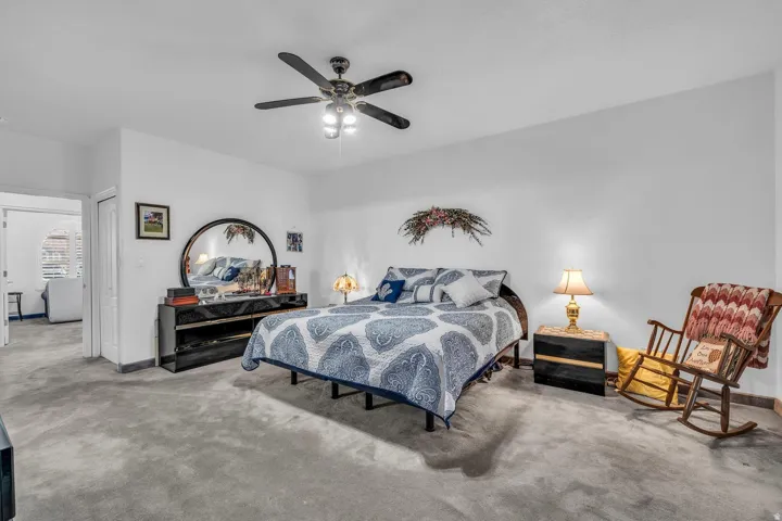 Recessed lighting, ceiling fan, and carpeted flooring